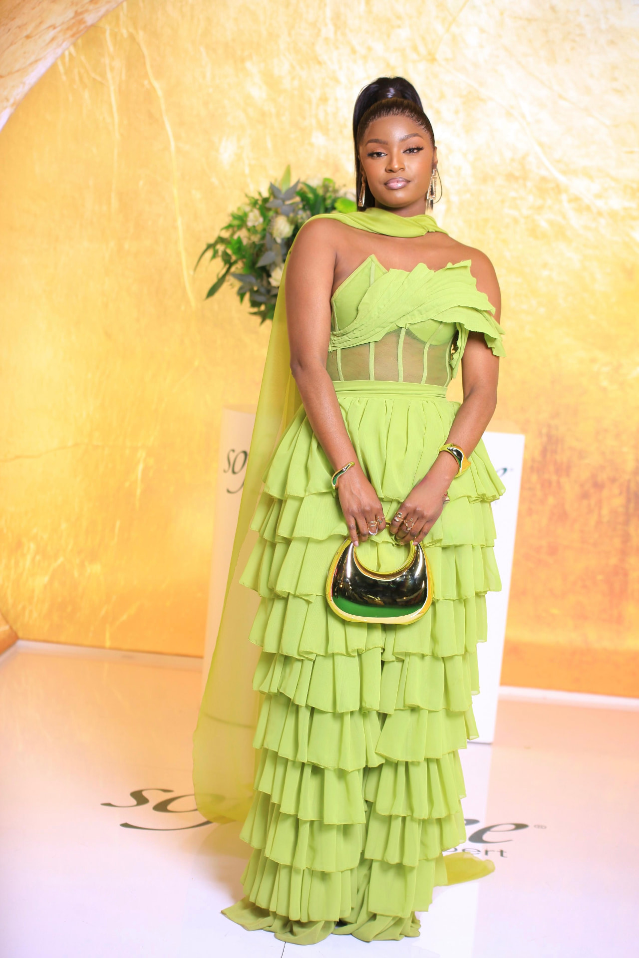 Musa Yende in a chartreuse tiered gown on the red carpet